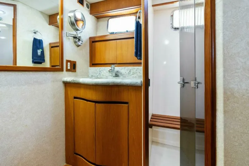 Orion II Yacht Photos Pics Luxurious bathroom in 2001 Grand Alaskan 64 Pilot House yacht with wooden cabinetry.