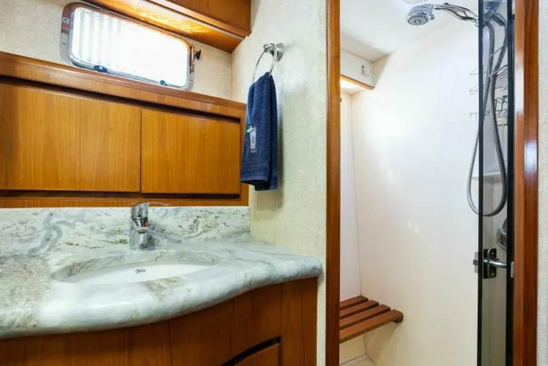 Orion II Yacht Photos Pics Luxurious bathroom in 2001 Grand Alaskan 64 Pilot House yacht with marble countertop and shower.