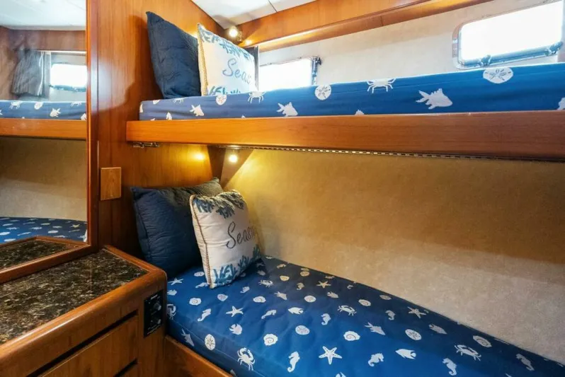 Orion II Yacht Photos Pics Bunk beds with nautical-themed bedding in a 2001 Grand Alaskan 64 pilot house yacht.