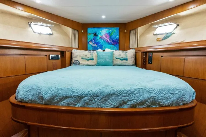 Orion II Yacht Photos Pics Luxurious bedroom in 2001 Grand Alaskan 64 Pilot House yacht with elegant wood paneling.