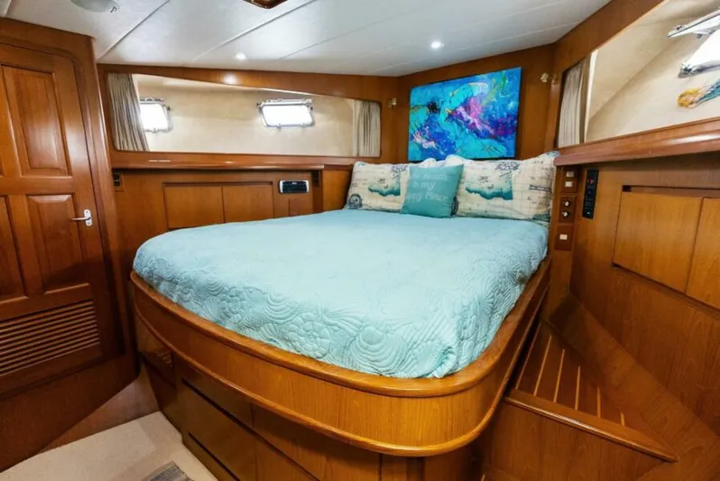 Orion II Yacht Photos Pics Luxurious bedroom in 2001 Grand Alaskan 64 Pilot House yacht with elegant wood finish.