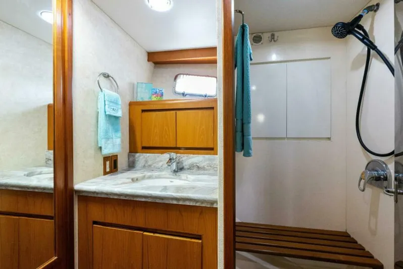 Orion II Yacht Photos Pics Luxurious bathroom in 2001 Grand Alaskan 64 Pilot House yacht, featuring wood cabinetry and modern fixtures.