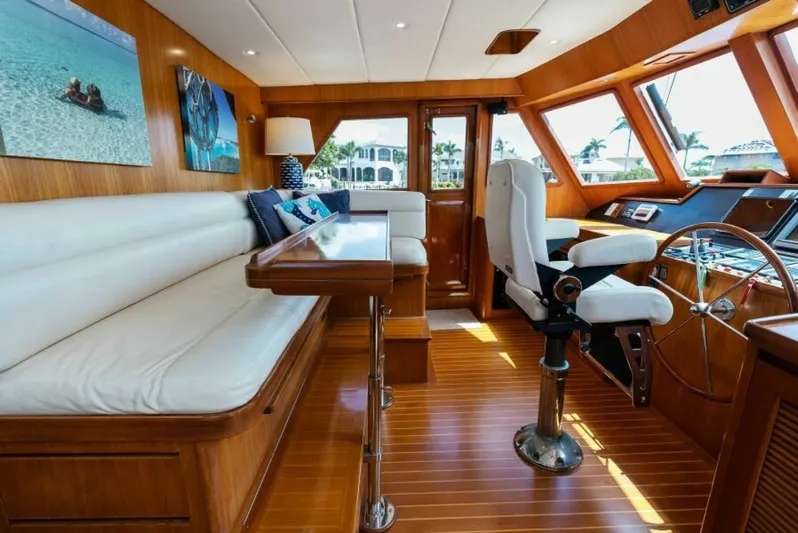 Orion II Yacht Photos Pics Luxurious 2001 Grand Alaskan 64 pilot house interior with wood finish and plush seating.