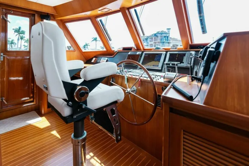 Orion II Yacht Photos Pics Pilot house interior of 2001 Grand Alaskan 64, featuring helm and navigation equipment.