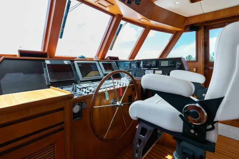 Orion II Yacht Photos Pics Pilot house interior of 2001 Grand Alaskan 64, featuring navigation equipment and captain's chair.