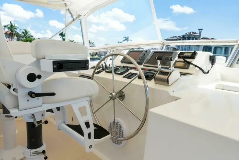 Orion II Yacht Photos Pics Pilot house of 2001 Grand Alaskan 64, featuring steering wheel and navigation controls.