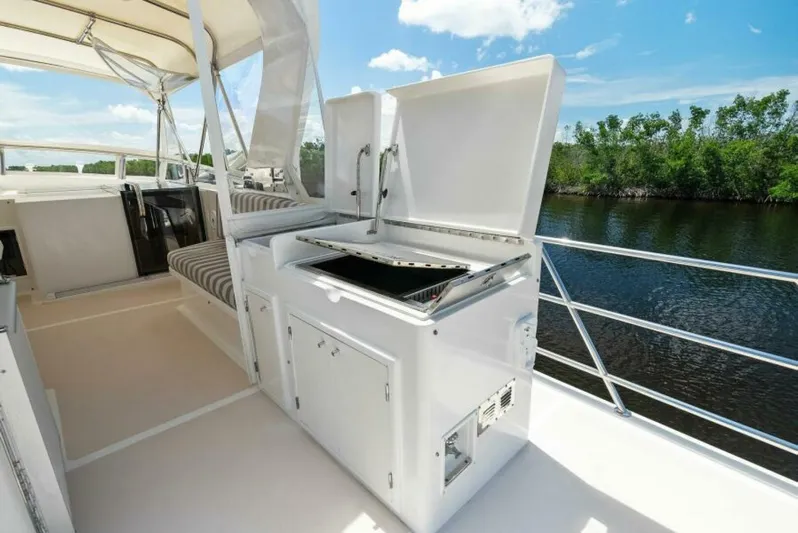 Orion II Yacht Photos Pics Outdoor kitchen on 2001 Grand Alaskan 64 pilot house yacht, featuring grill and seating.