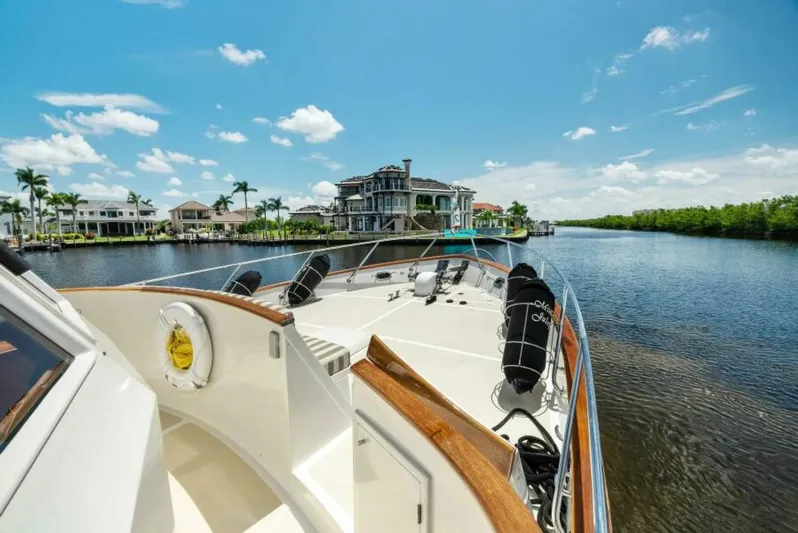 Orion II Yacht Photos Pics Grand Alaskan 64 Pilot House yacht cruising near waterfront homes, 2001 model.