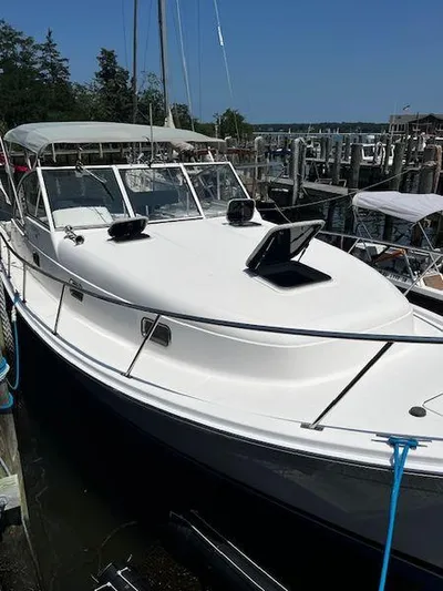  Yacht Photos Pics 2003 Mainship Pilot 34 boat docked at marina, featuring sleek white design and spacious deck.