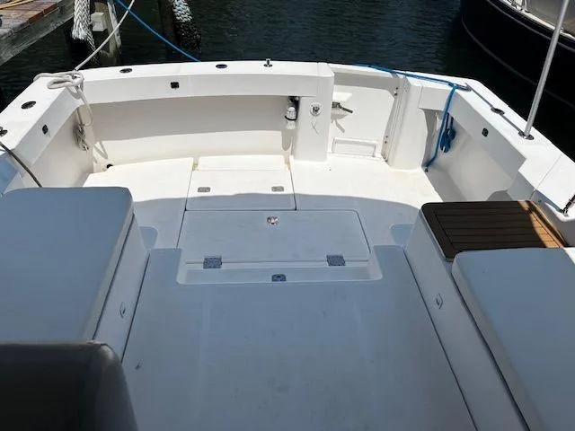  Yacht Photos Pics 2003 Mainship Pilot 34 boat deck with seating, docked at marina.