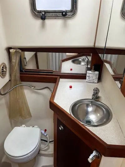  Yacht Photos Pics 2003 Mainship Pilot 34 bathroom with sink, toilet, and mirror.