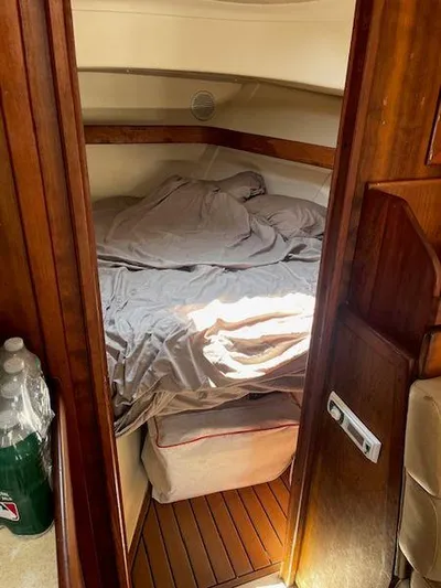  Yacht Photos Pics Cozy cabin interior of 2003 Mainship Pilot 34 with bed and wooden accents.