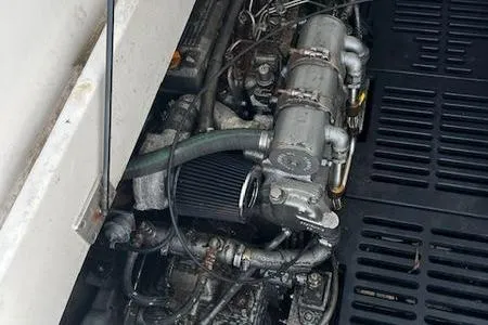  Yacht Photos Pics Engine compartment of a 2003 Mainship Pilot 34 boat, showing mechanical components and hoses.