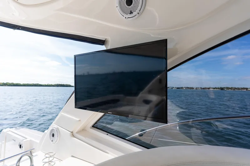  Yacht Photos Pics 2005 Sea Ray 48 Sundancer yacht with a mounted TV, overlooking serene waters.