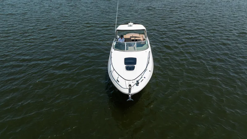  Yacht Photos Pics 2016 Sea Ray 310 Sundancer cruising on open water, aerial view.