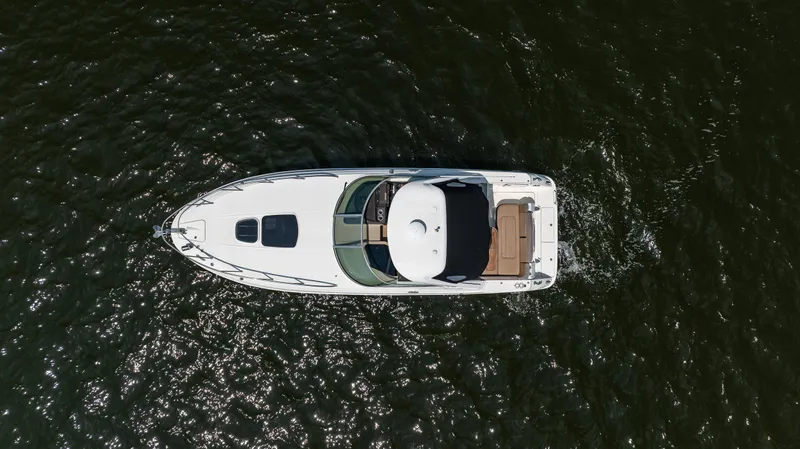  Yacht Photos Pics Aerial view of 2016 Sea Ray 310 Sundancer yacht cruising on water.