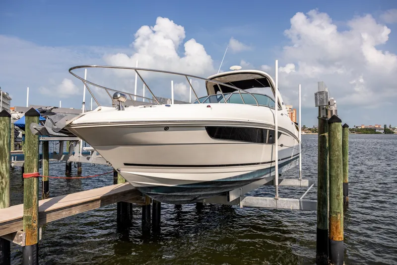  Yacht Photos Pics 2016 Sea Ray 310 Sundancer boat on lift, docked by waterfront.