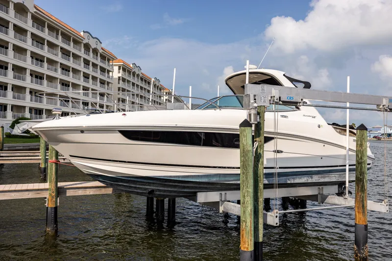  Yacht Photos Pics 2016 Sea Ray 310 Sundancer boat docked near waterfront buildings.