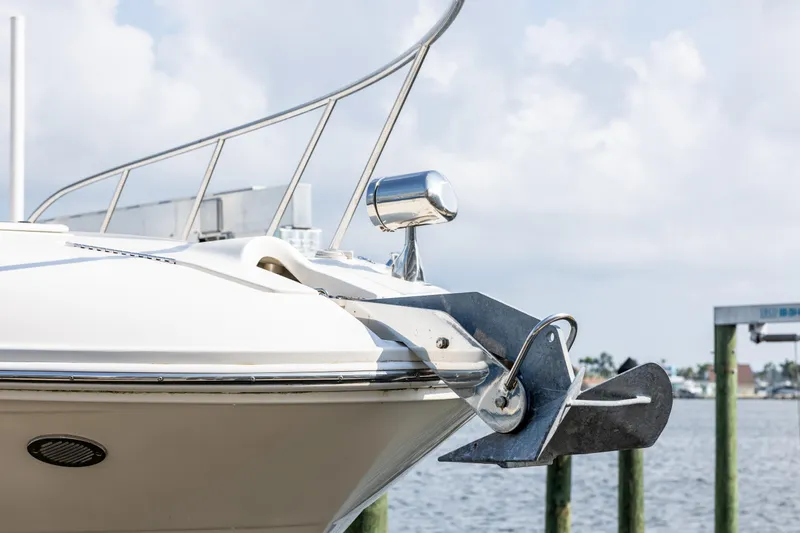  Yacht Photos Pics 2016 Sea Ray 310 Sundancer boat bow with anchor, docked by the water.