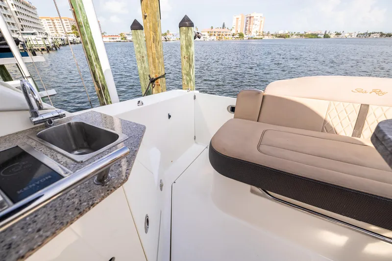  Yacht Photos Pics 2016 Sea Ray 310 Sundancer boat interior with sink and seating by the water.