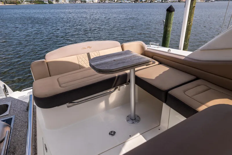  Yacht Photos Pics 2016 Sea Ray 310 Sundancer boat interior with seating and table by the water.