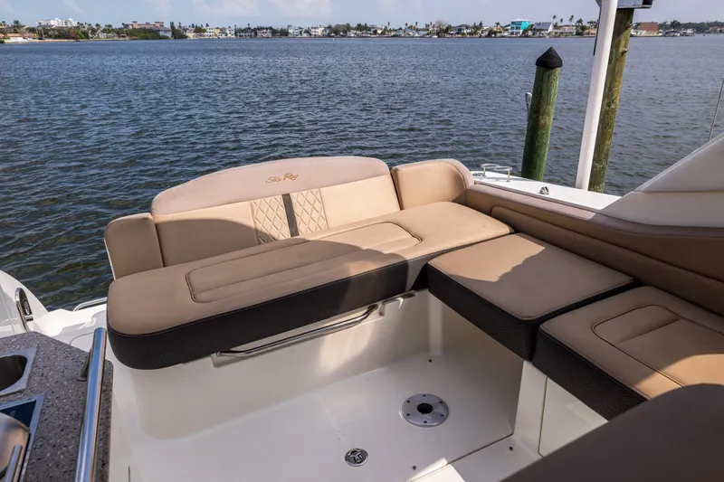  Yacht Photos Pics 2016 Sea Ray 310 Sundancer boat interior with beige seating, overlooking calm waters.