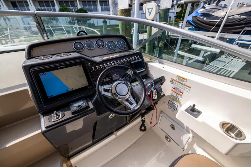  Yacht Photos Pics 2016 Sea Ray 310 Sundancer helm with navigation display and steering wheel.