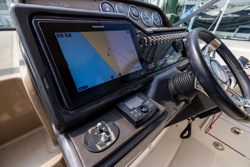  Yacht Photos Pics 2016 Sea Ray 310 Sundancer helm with navigation display and steering wheel.