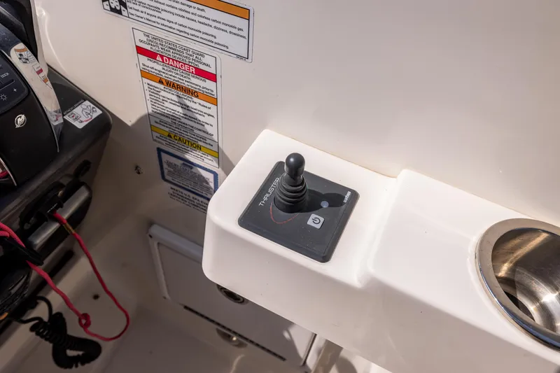  Yacht Photos Pics Control panel of a 2016 Sea Ray 310 Sundancer boat with joystick and warning labels.