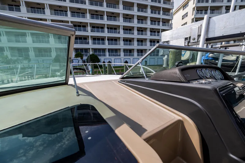  Yacht Photos Pics 2016 Sea Ray 310 Sundancer boat docked near waterfront buildings.