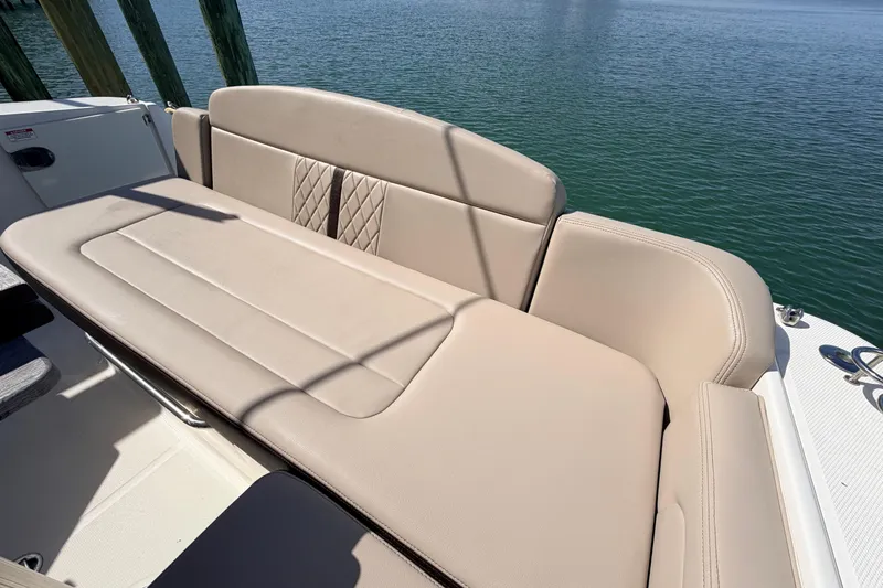  Yacht Photos Pics 2016 Sea Ray Sundancer 310 boat with beige seating, docked by calm water.