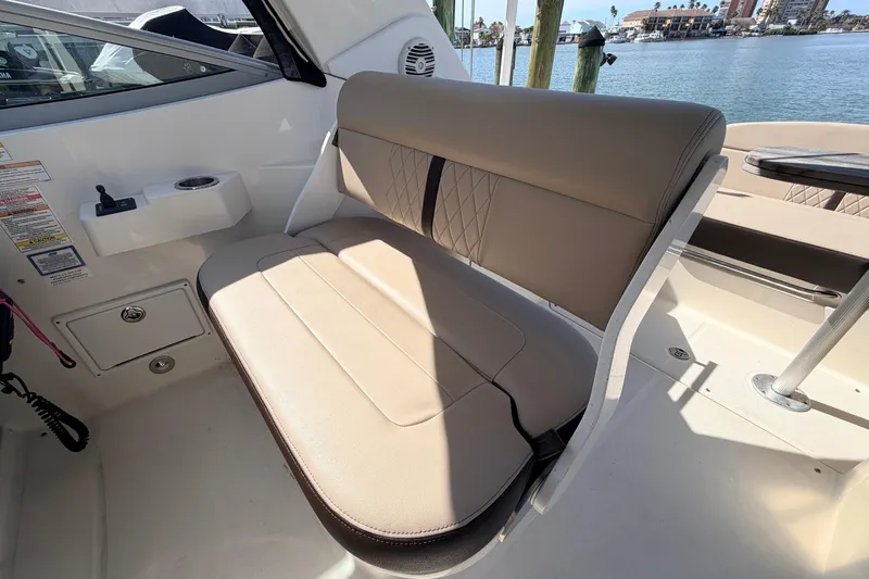  Yacht Photos Pics 2016 Sea Ray Sundancer 310 interior seating with beige upholstery and waterfront view.