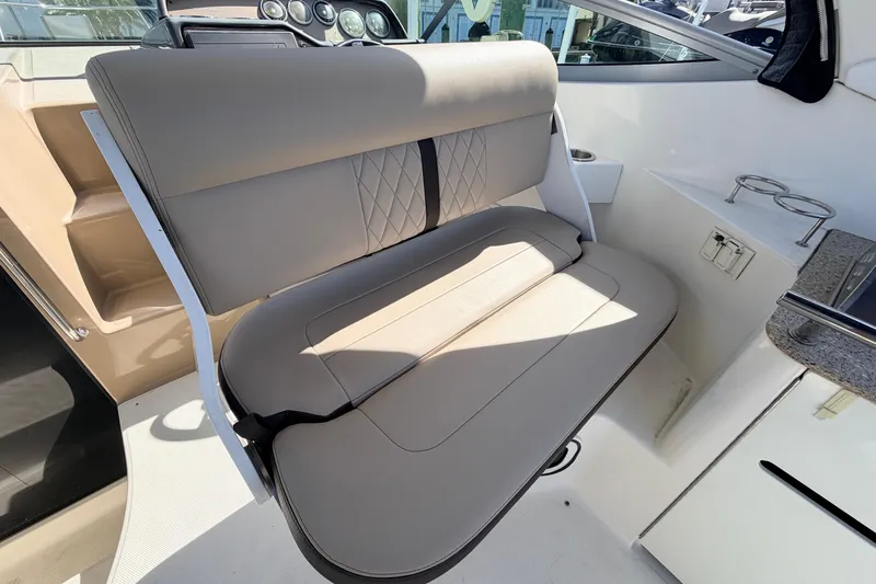  Yacht Photos Pics 2016 Sea Ray Sundancer 310 boat interior with cushioned seating and control panel.
