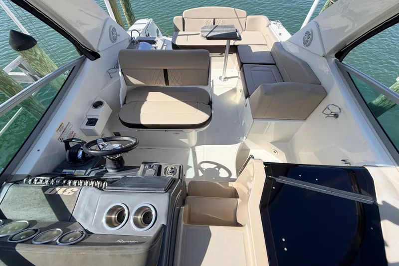  Yacht Photos Pics 2016 Sea Ray Sundancer 310 interior with helm, seating, and table on water.