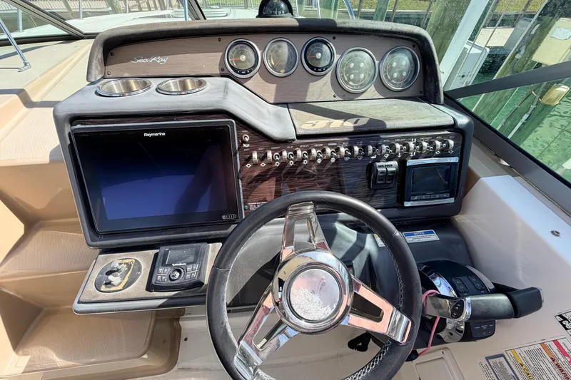  Yacht Photos Pics 2016 Sea Ray Sundancer 310 helm with steering wheel, gauges, and navigation display.