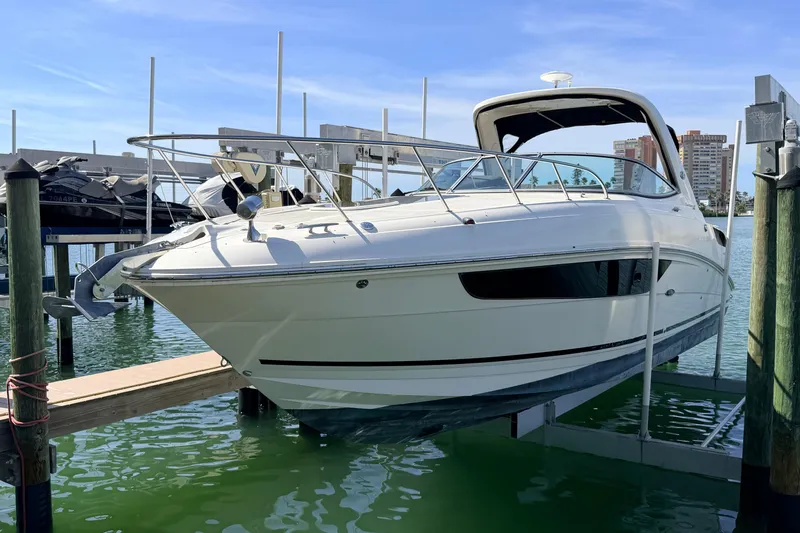  Yacht Photos Pics 2016 Sea Ray Sundancer 310 boat docked at marina, clear sky background.