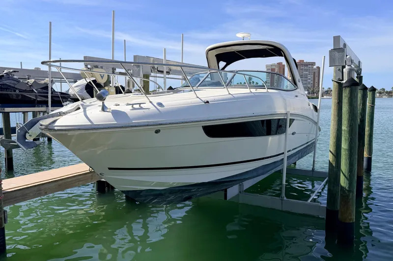  Yacht Photos Pics 2016 Sea Ray Sundancer 310 yacht docked on a lift in a marina.