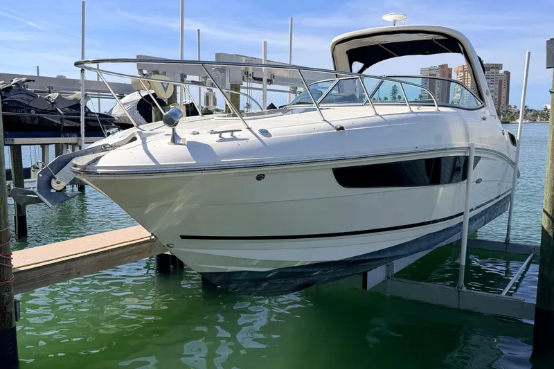  Yacht Photos Pics 2016 Sea Ray Sundancer 310 boat docked in marina, clear sky background.