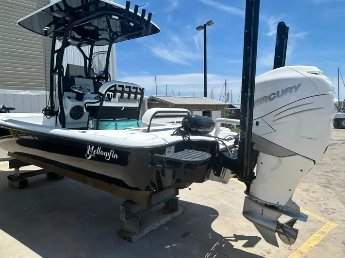  Yacht Photos Pics 2021 Yellowfin 24 Bay CE boat with Mercury engine, docked outdoors under clear sky.