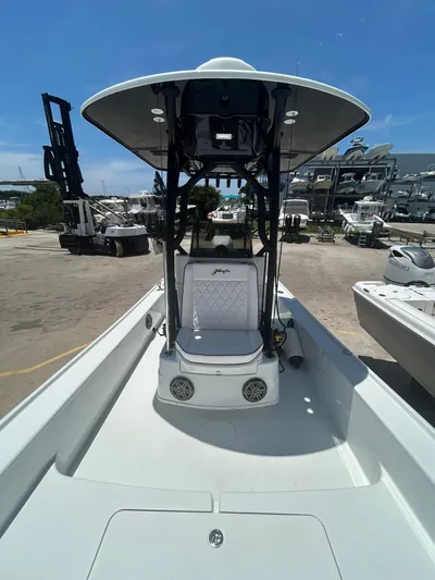  Yacht Photos Pics 2021 Yellowfin 24 Bay CE boat with center console, docked at a marina under clear skies.