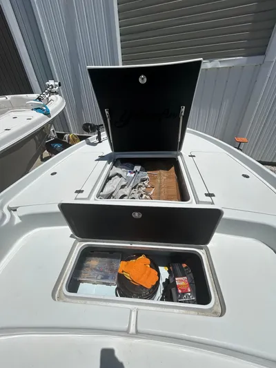  Yacht Photos Pics 2021 Yellowfin 24 Bay CE boat storage compartments open, showcasing interior space.