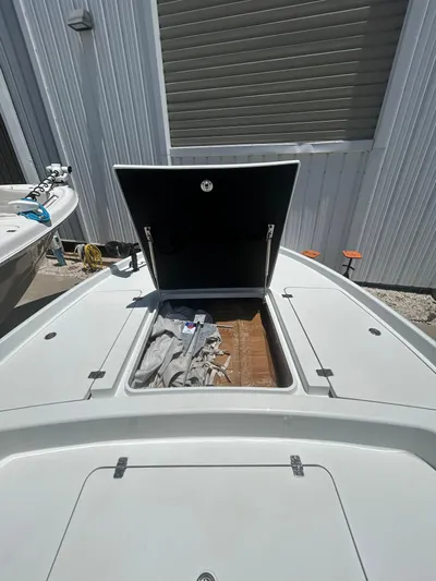  Yacht Photos Pics 2021 Yellowfin 24 Bay CE boat with open storage compartment.
