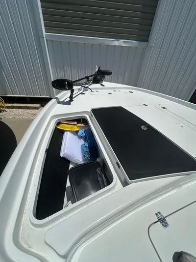  Yacht Photos Pics 2021 Yellowfin 24 Bay CE boat with open storage compartment and cleaning supplies.