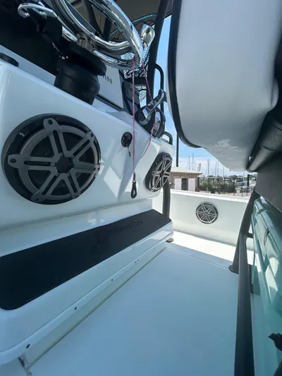  Yacht Photos Pics 2021 Yellowfin 24 Bay CE boat interior with speakers and steering wheel.