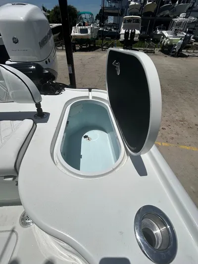  Yacht Photos Pics 2021 Yellowfin 24 Bay CE boat with open storage compartment and Mercury engine.