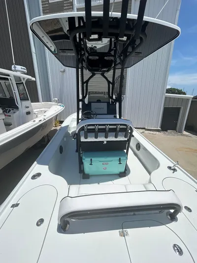  Yacht Photos Pics 2021 Yellowfin 24 Bay CE boat with T-top and Yeti cooler, docked outdoors.