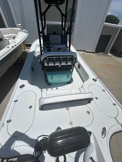  Yacht Photos Pics 2021 Yellowfin 24 Bay CE boat with center console and seating, docked outdoors.
