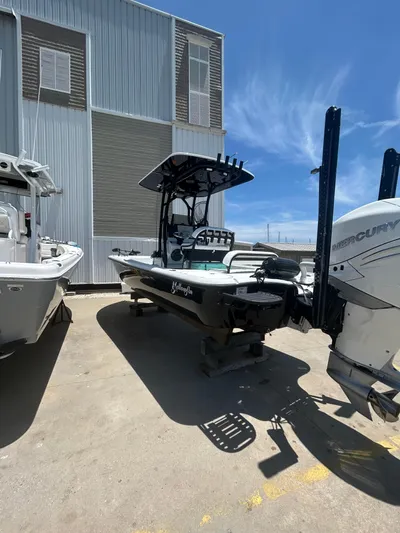  Yacht Photos Pics 2021 Yellowfin 24 Bay CE boat with Mercury engine, parked outdoors under clear sky.