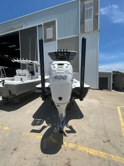  Yacht Photos Pics 2021 Yellowfin 24 Bay CE boat with powerful Verado 400 engine, parked outside a warehouse.