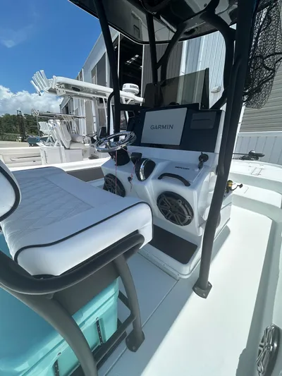  Yacht Photos Pics 2021 Yellowfin 24 Bay CE boat interior with Garmin navigation system and seating.